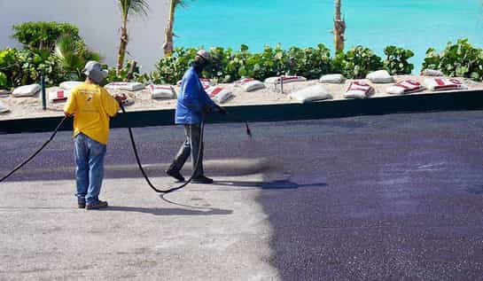 Sealcoating workers are covered by asphalt maintenance company's insurance policy